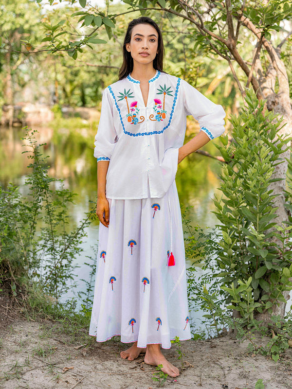 Elegant tropical summer look with embroidered monkey blouse and white skirt