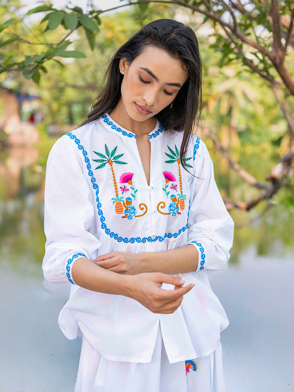 Detailed front view of symmetrical monkey embroidery and ruffled collar