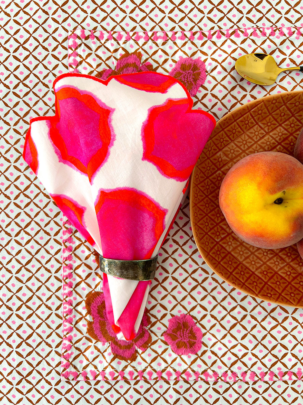 close-up of ikat pink orange print on premium linen napkin