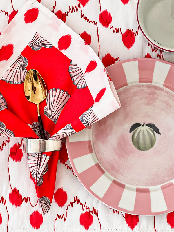 Elegant summer table setting featuring maritime shells and dots napkins