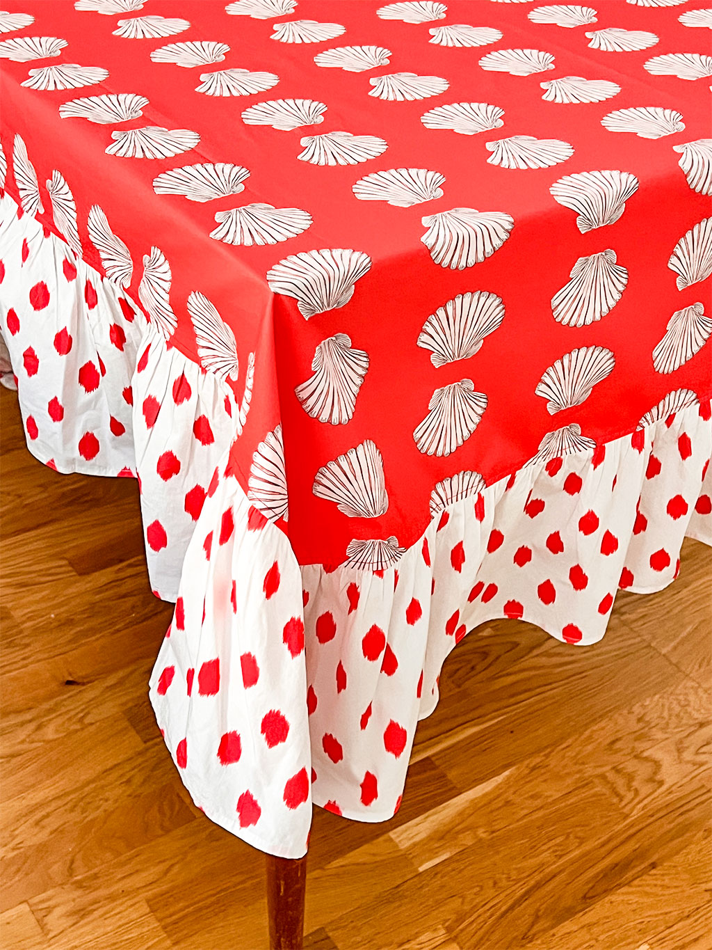 Detailed view of hand-printed seashell motif and contrasting dot ruffle