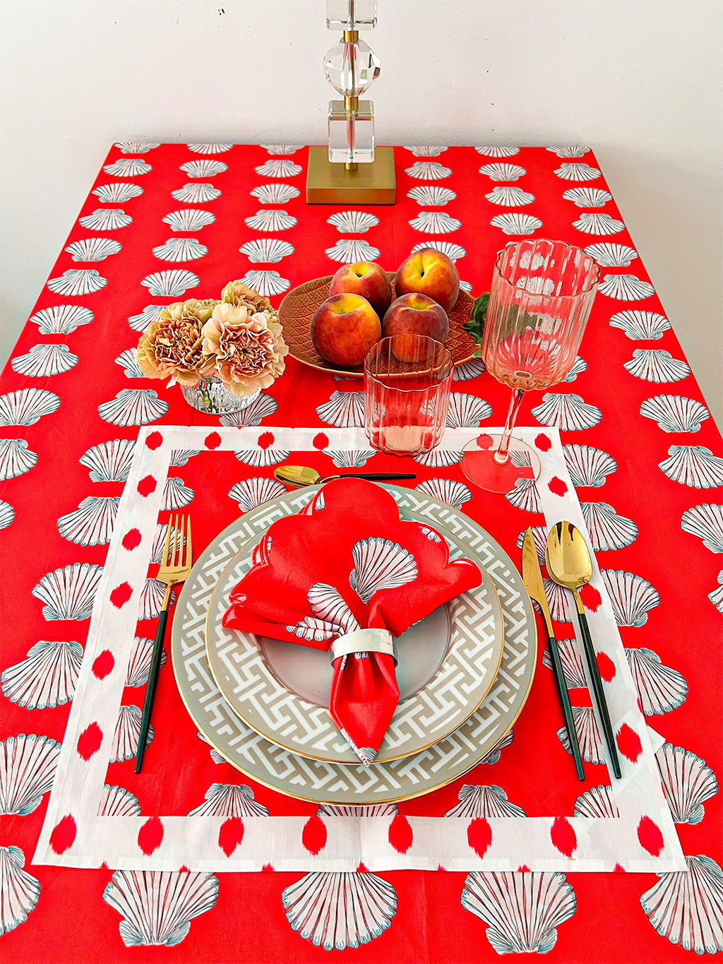 Festive coastal tablescape with Nimo With Love seashell and dots design