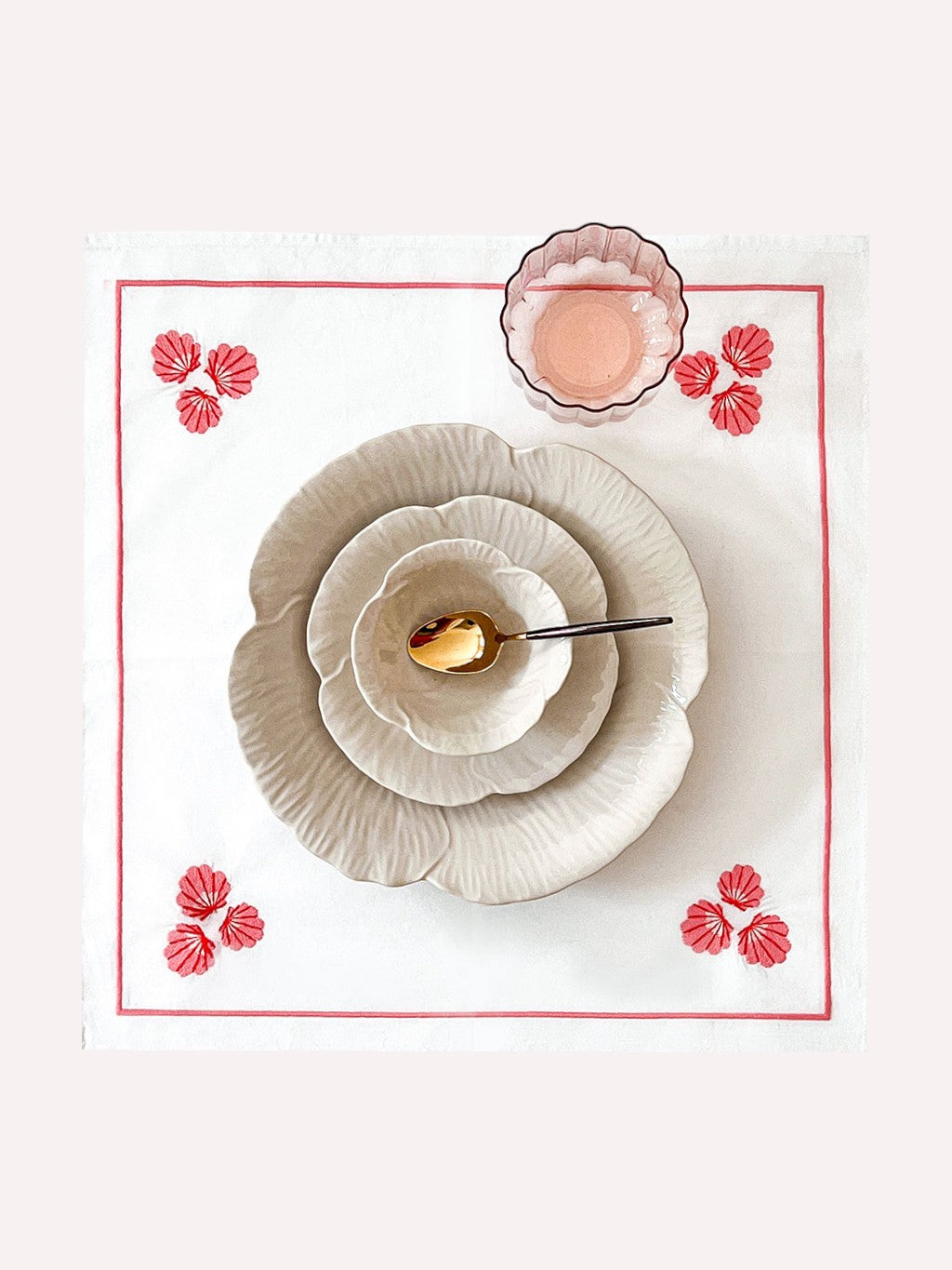 Coastal-inspired tablescape featuring Nimo With Love shell linens