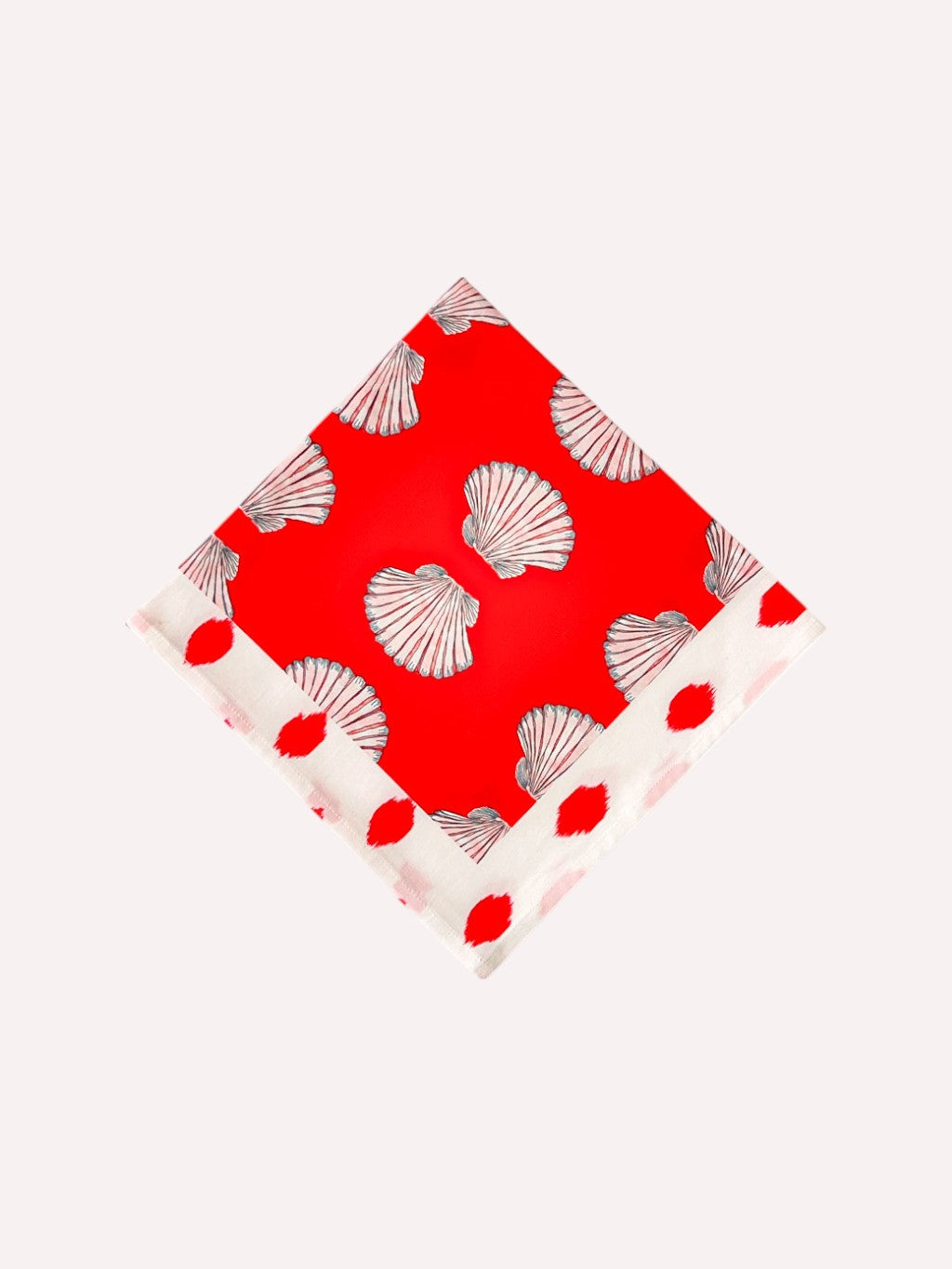 Shells on red organic cotton napkin with decorative dot border by Nimo With Love