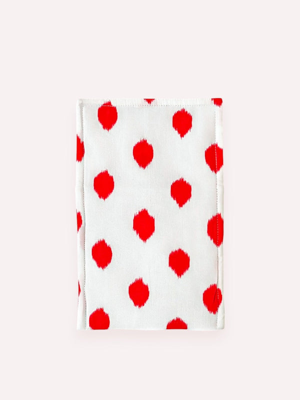 Backside of Nimo cutlery bag with hand-printed red ikat dots and ornamental embroidery