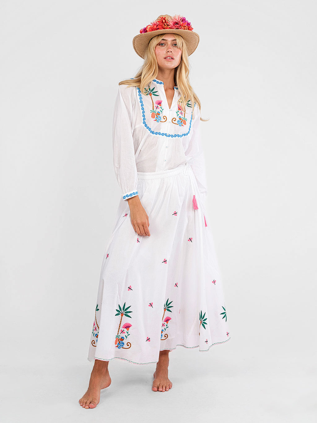 Elegant tropical summer look with embroidered monkey blouse and white skirt