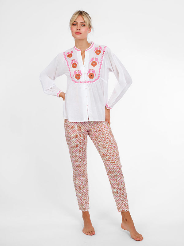 White organic cotton Catnep blouse by Nimo With Love featuring vibrant bird and floral embroidery on the front yoke.