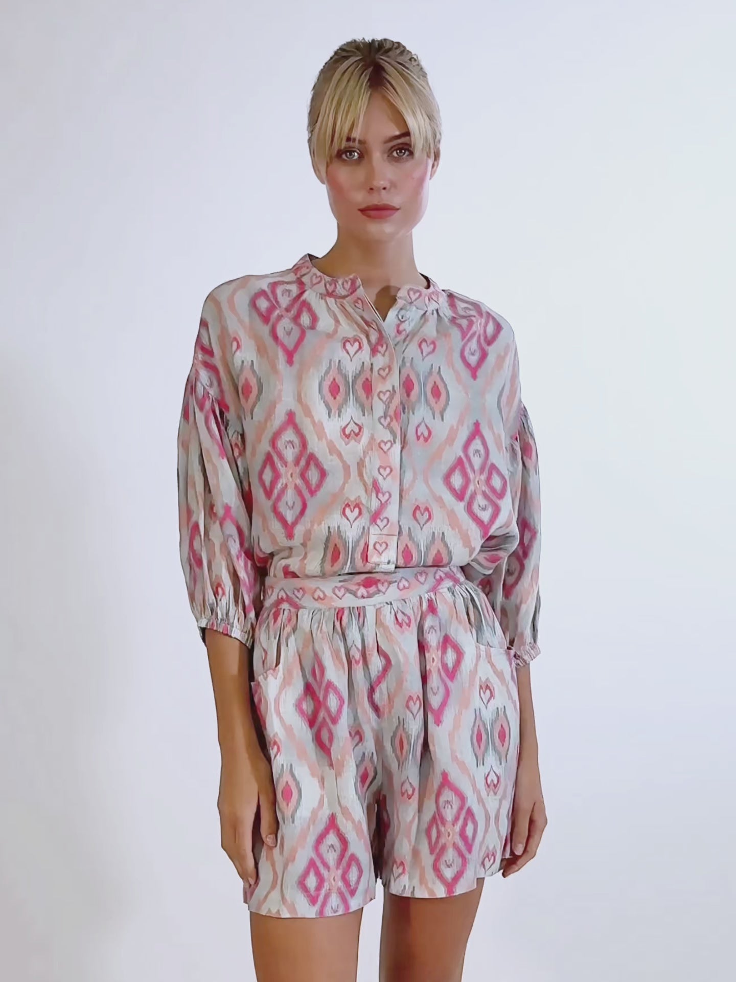 Video of a model wearing the Lilly Pilly linen shorts in ikat sorbet, paired with a matching embroidered wrap blouse.