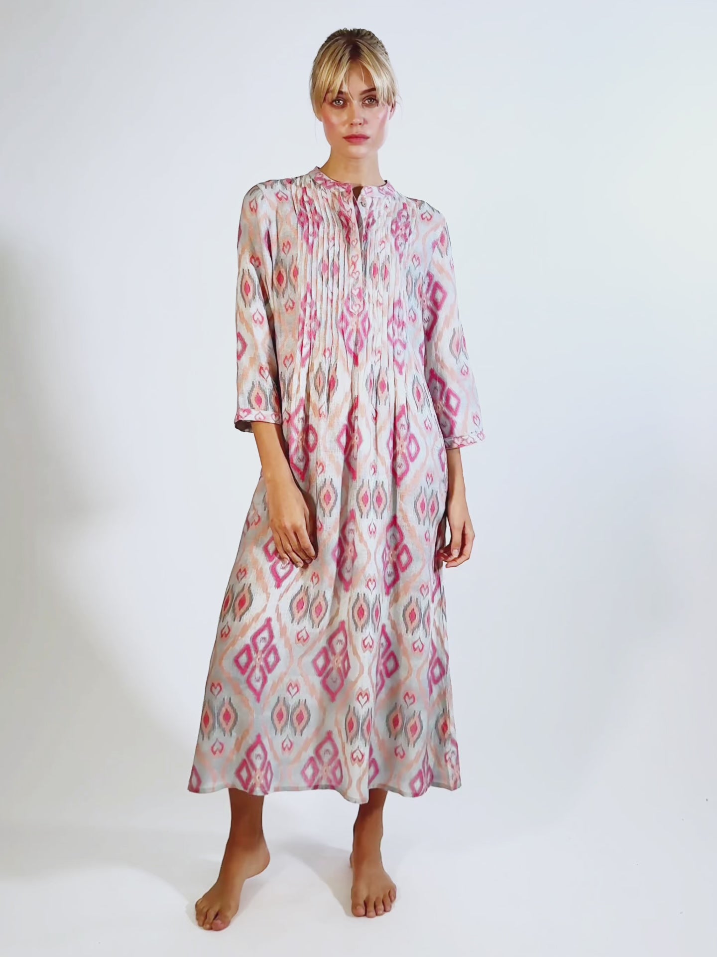 VIdeo showing the ankle-length Woodruff dress by Nimo With Love in fluid linen featuring intricate vertical pleating on the bodice.
