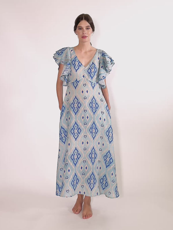 A fluid linen maxi summer dress cut from natural linen to a relaxed, easy-fitting silhouette with ruffled statement sleeves
