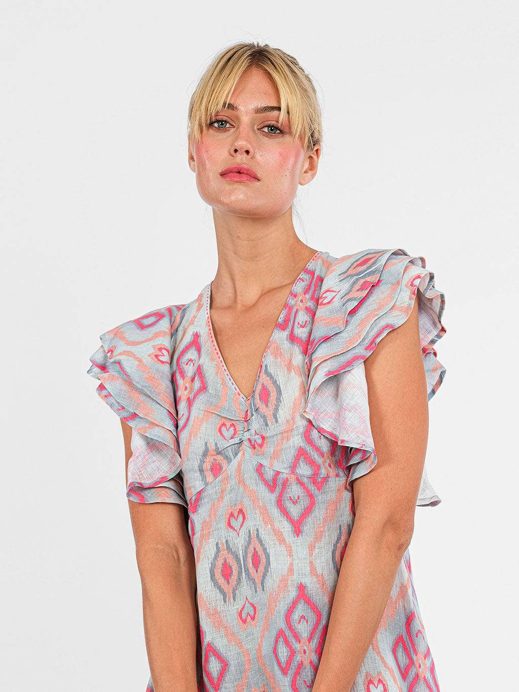 Detailed shot of the architectural layered ruffle cap sleeves on the premium linen Belladonna dress.