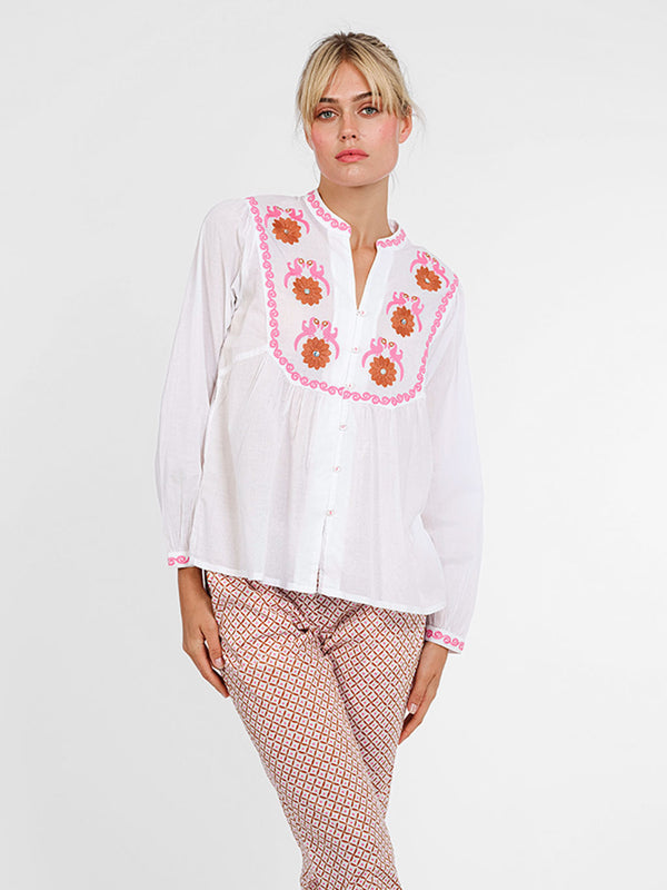 White organic cotton button down Catnep blouse by Nimo With Love featuring vibrant bird and floral embroidery on the front yoke.